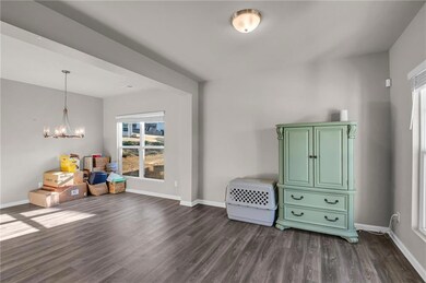 Living area with dark wood-type flooring and an in