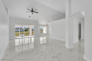 Spare room with arched walkways, marble finish flo