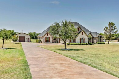 Long driveway that leads to the shed and garage