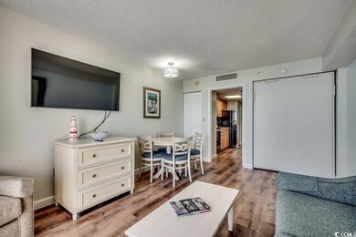 Living area featuring a textured ceiling, wood fin