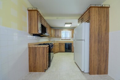Galley kitchen with  gas stove and dishwasher with