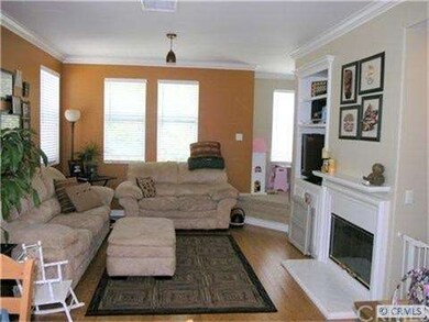 Living room with cozy fireplace and bamboo floors