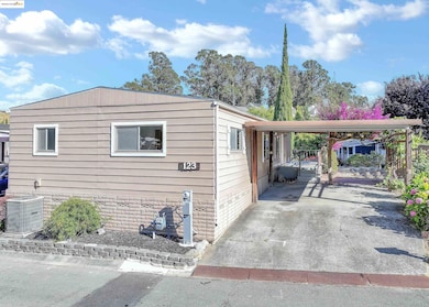 View of home's exterior with driveway and a carport