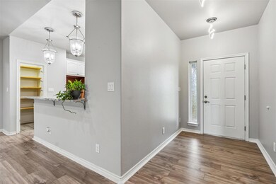 Foyer entrance with an inviting chandelier and hardwood / wood-style flooring