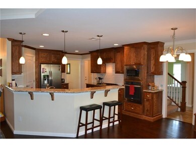 The kitchen has upgraded stainless appliances, lar
