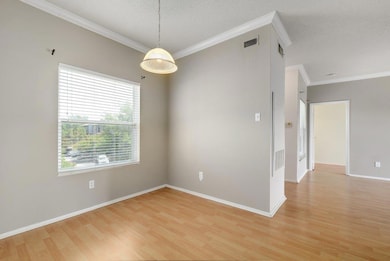 Unfurnished room featuring ornamental molding, ba