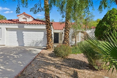 Mediterranean / spanish-style home with concrete driveway, a garage, stucco siding, and a tiled roof