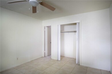 Unfurnished bedroom with light tile patterned floo