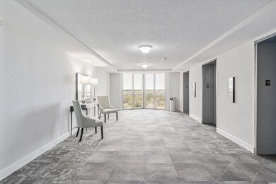 Sitting room featuring elevator, expansive windows