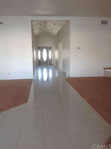 Hallway looking at front door. Living room on the 