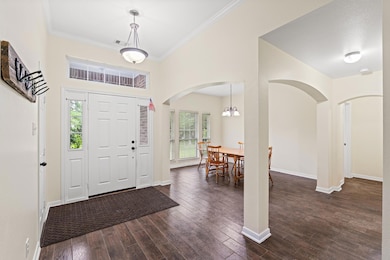 Foyer featuring arched walkways, healthy amount o