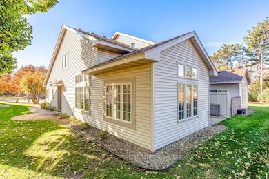 Bright and inviting exterior with large windows that fill the interior with natural light and offer serene views of the lush surroundings.