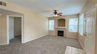 Unfurnished living room featuring a ceiling fan, a