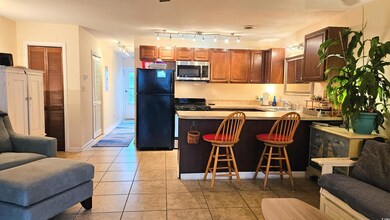 Kitchen with open floor plan, light countertops, a