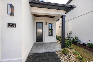 Entrance to property with stucco siding