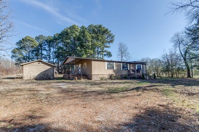 The home features a covered front porch and covered side porch. A Gardening/Craft building is located nearby.