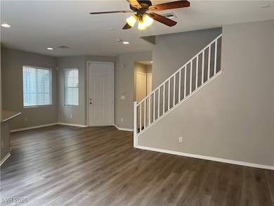 Entrance foyer with baseboards, stairs, ceiling fa