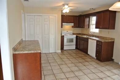 Spacious kitchen with built in desk and tile floor