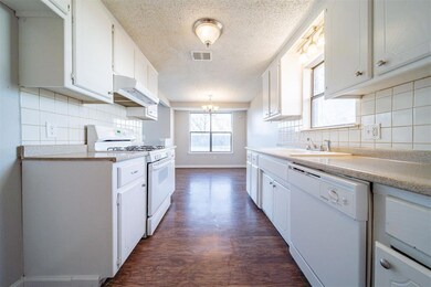 Kitchen with sink, white appliances, dark wood-typ