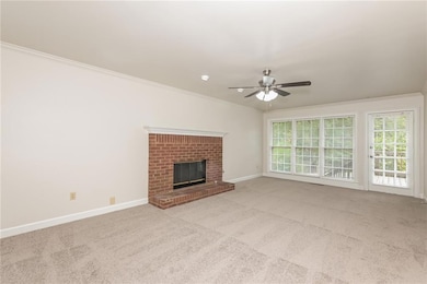 Unfurnished living room with crown molding, light 