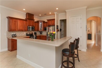 Open kitchen with 42 inch maple cabinets and Coria