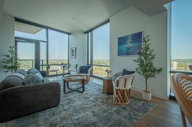 Living area with baseboards, expansive windows, a