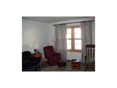 Spacious Living Room with Hardwoods under Carpet