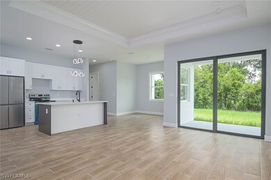 Kitchen with light wood-type flooring, an island w