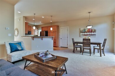 The great room floor plan also has space for bar stools by the kitchen counter.  The door opens to the garage.
