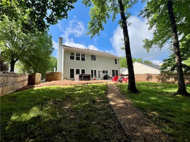 Back of property featuring a fenced backyard, a pa