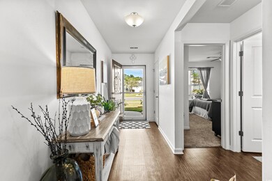 Foyer entrance featuring ceiling fan, dark wood-ty