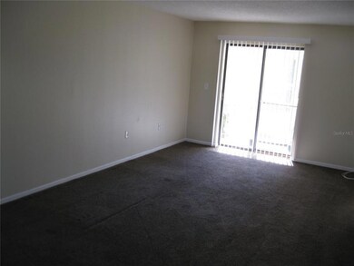 LIVING ROOM SHOWING SLIDING GLASS DOORS TO SCREENED LANAI.