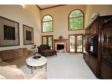 Two story great room has fireplace flanked by two 