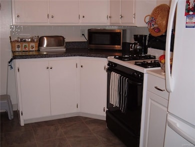 Fully applianced kitchen with newer floor.