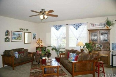 View family room with ceiling fan.