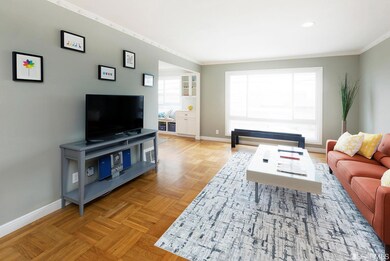The living room is awash in light from expansive windows.