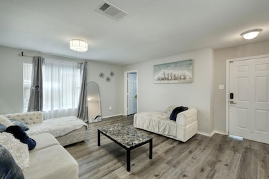 Living area with wood finished floors and baseboa