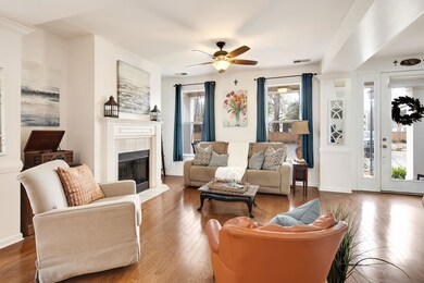 Living room featuring visible vents, a tile firepl
