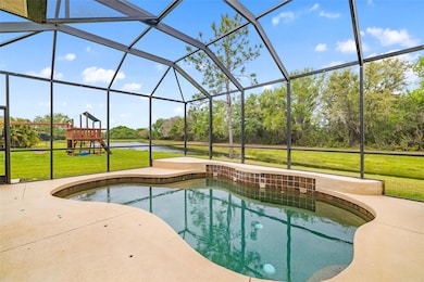 Fully screened private pool with tranquil waterfall, views of nature preserve, and double lake view is your very own private Oasis.