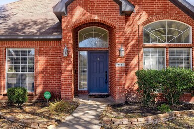 View of exterior entry featuring a shingled roof a