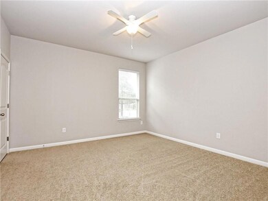Spare room with a ceiling fan, baseboards, and li