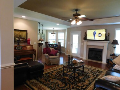 ANOTHER VIEW OF OPEN GREAT ROOM WITH FIREPLACE