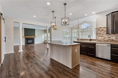 Kitchen with view into open plan family room and m
