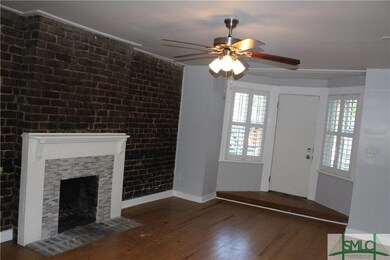 LIVING ROOM WITH HARDWOOD FLRS EXPOSED BRICK WALL 