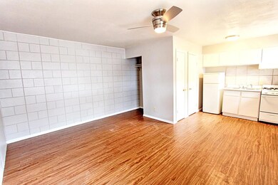 Unfurnished living room featuring ceiling fan, ti
