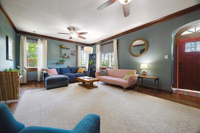 Living area with baseboards, a textured ceiling, a