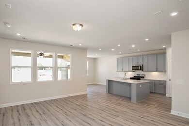 One view of the great room/kitchen from garage entry. Similar home, same plan. Colors and selections may vary.
