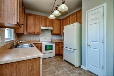 Kitchen with refrigerator overlooking backyard.