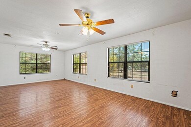 Empty room featuring a textured ceiling, plenty o