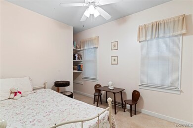 Carpeted bedroom with ceiling fan